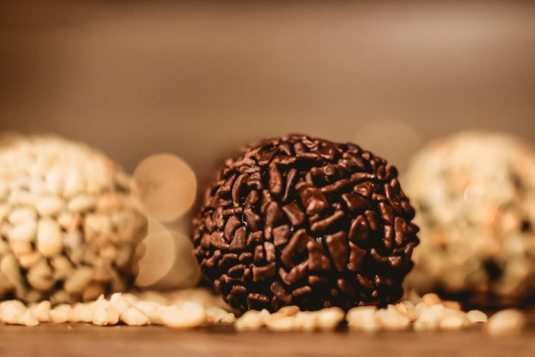 Close-up shot of assorted chocolate brigadeiros, highlighting textures and indulgence.